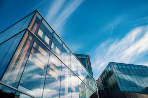 bright payroll office behind a clear blue sky with large glass windows